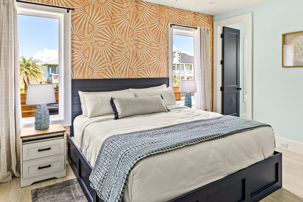 Styled bedroom in a Bolivar Peninsula vacation rental with coastal decor and ocean view windows