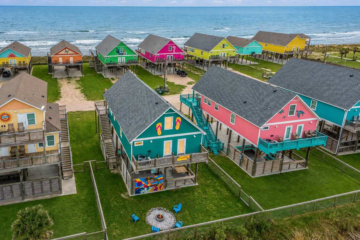 Aerial view of colorful beachfront vacation rental homes on stilts in Crystal Beach Texas at sunset