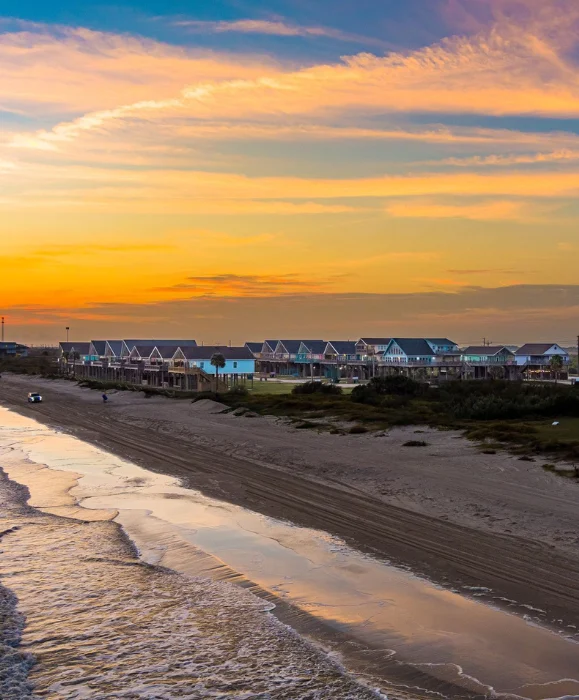 Sunset view over Bolivar Peninsula beachfront house rentals in Crystal Beach, Texas