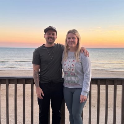 Felipe and Julie Caldeira on a deck overlooking Bolivar Peninsula beach