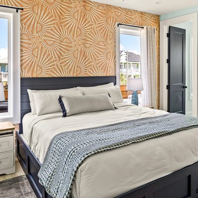 Styled bedroom in a Bolivar Peninsula vacation rental with coastal decor and ocean view windows